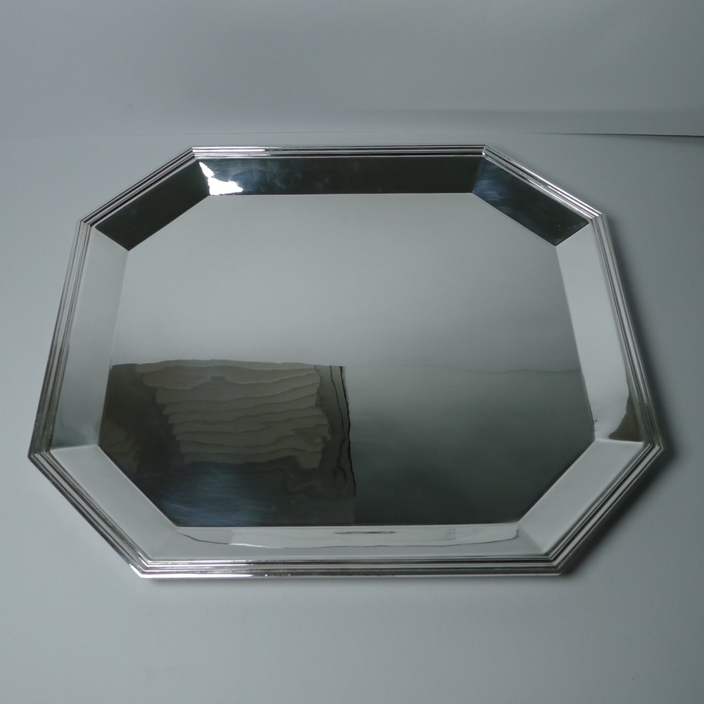 An octagonal silver-plated Art Deco tray featuring a polished reflective surface and a stepped moulded border.
