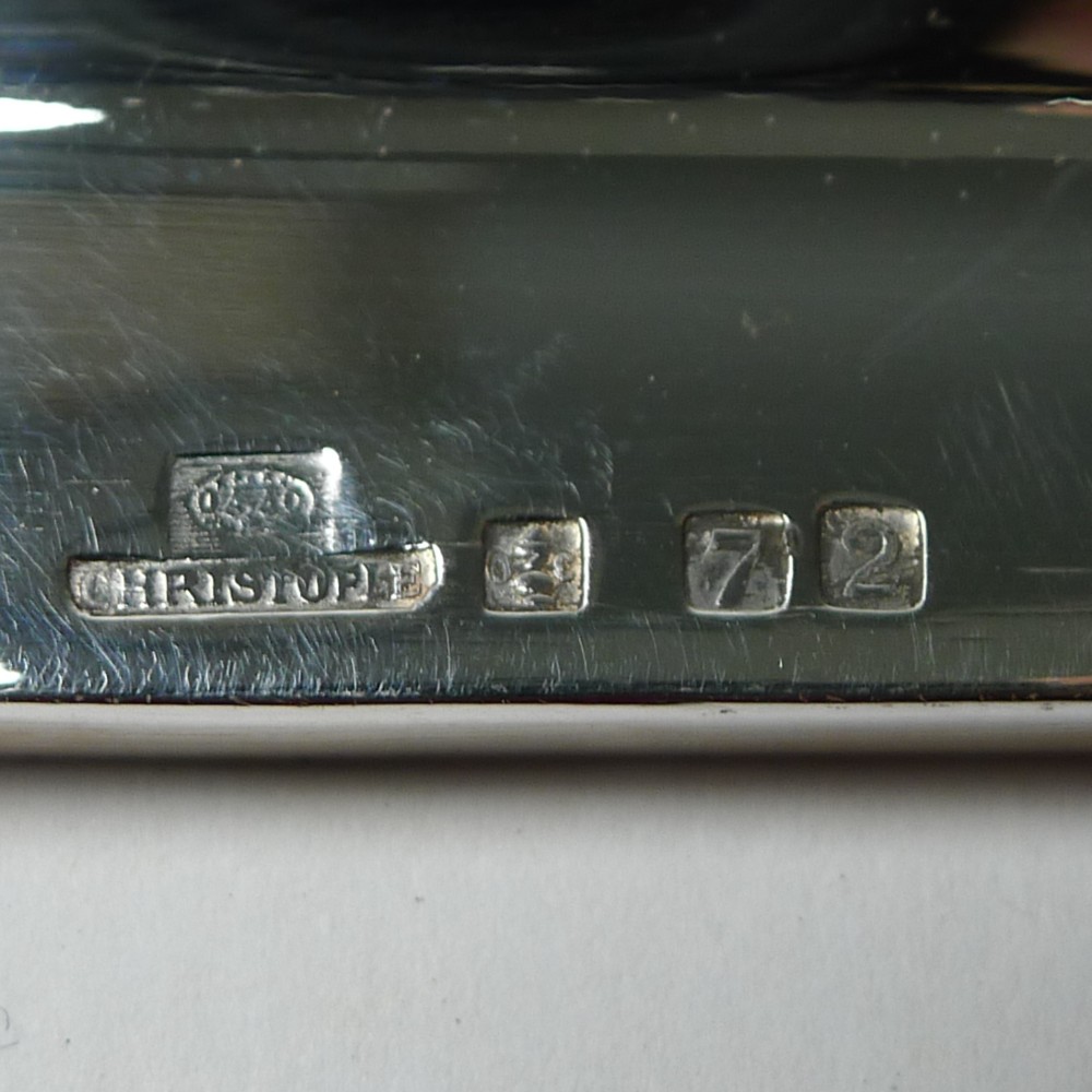 An octagonal silver-plated Art Deco tray featuring a polished reflective surface and a stepped moulded border. View III