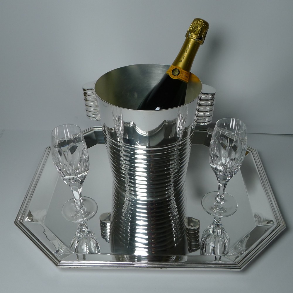 An octagonal silver-plated Art Deco tray featuring a polished reflective surface and a stepped moulded border. View IV