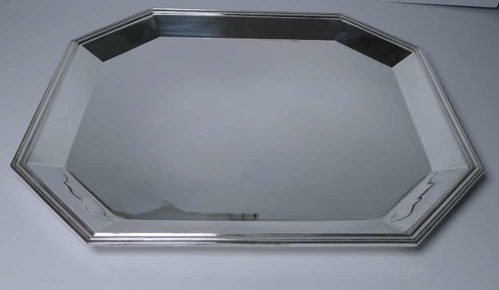 An octagonal silver-plated Art Deco tray featuring a polished reflective surface and a stepped moulded border. View VII