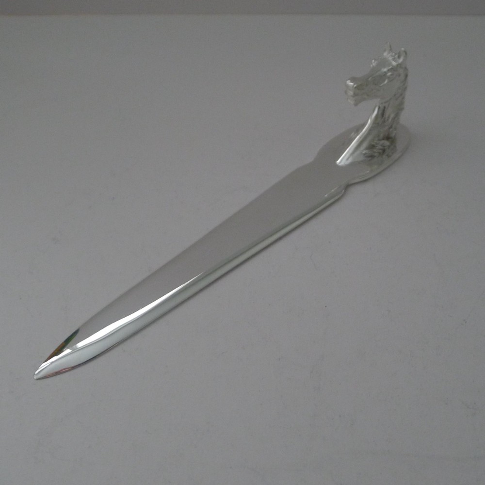 A silvered bronze letter opener featuring a detailed sculpted horse head handle and a polished, tapered blade resting on a neutral background.