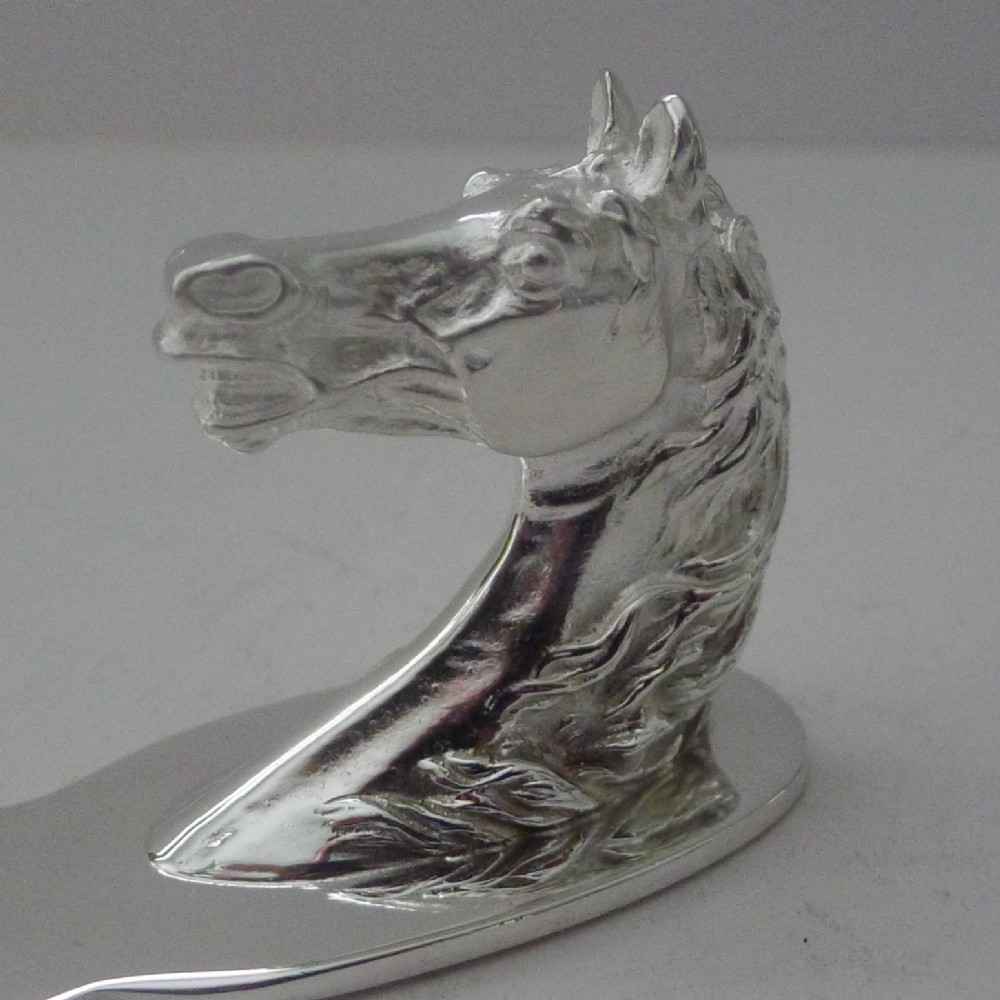 A silvered bronze letter opener featuring a detailed sculpted horse head handle and a polished, tapered blade resting on a neutral background. View V
