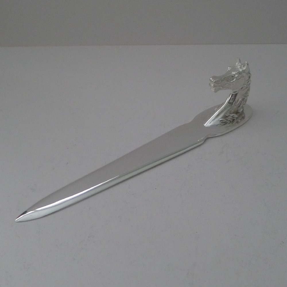 A silvered bronze letter opener featuring a detailed sculpted horse head handle and a polished, tapered blade resting on a neutral background. View VI