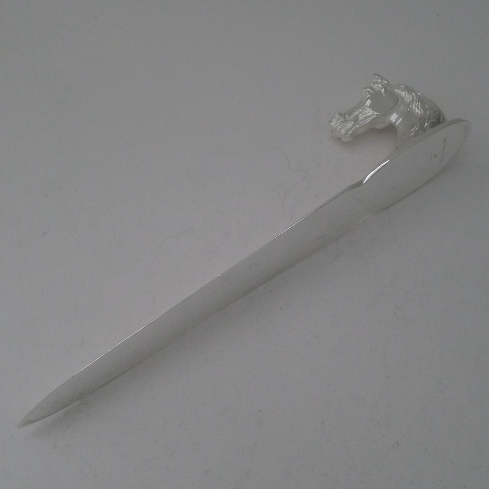 A silvered bronze letter opener featuring a detailed sculpted horse head handle and a polished, tapered blade resting on a neutral background. View IX