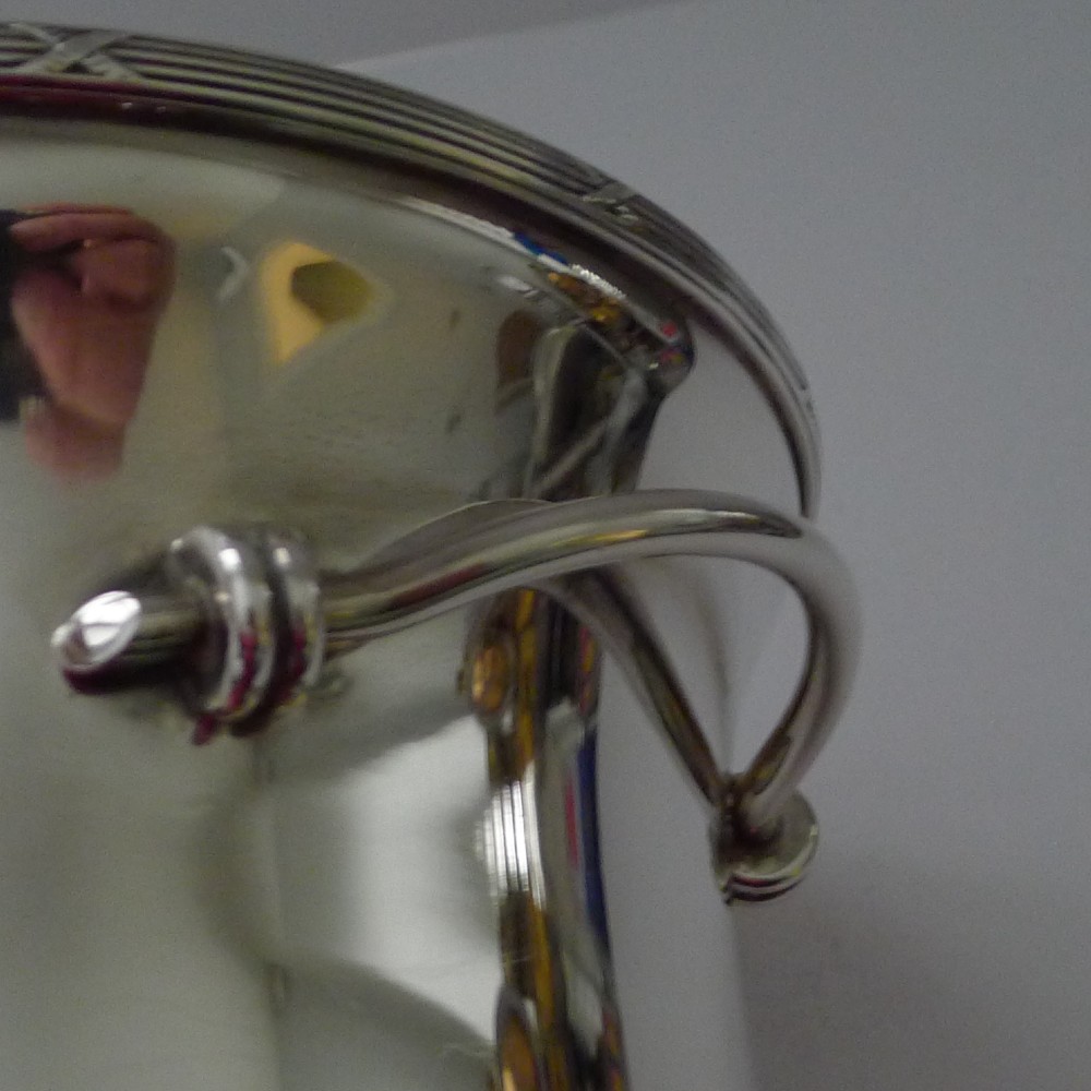 A polished silver-plated French champagne bucket with twin side handles and a detailed reeded rim. View V