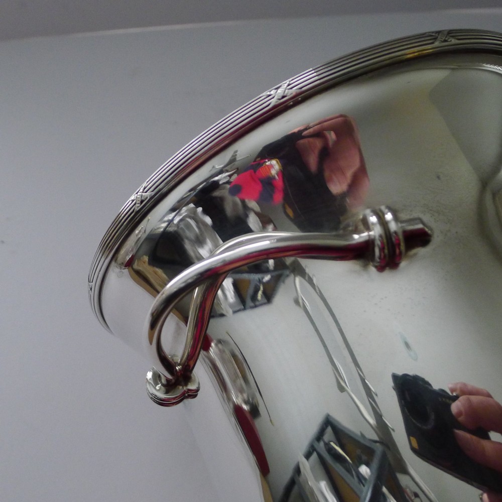 A polished silver-plated French champagne bucket with twin side handles and a detailed reeded rim. View XI