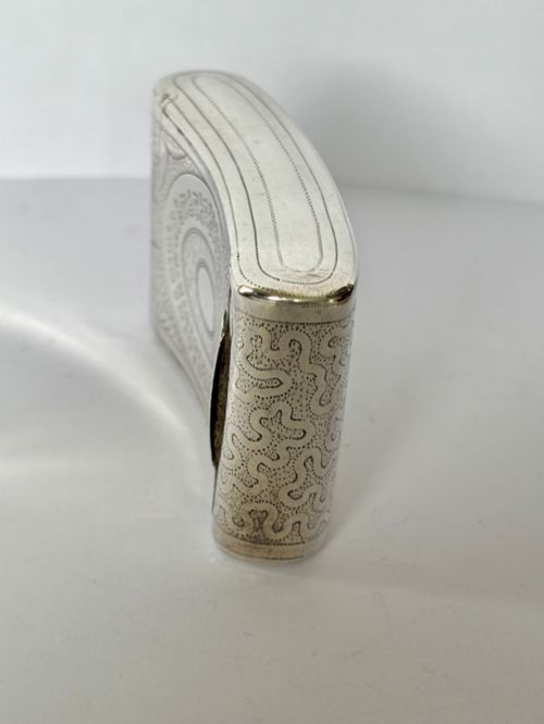 fig 2. A curved antique sterling silver pocket snuff box featuring elaborate hand engraving and a flush hinge.