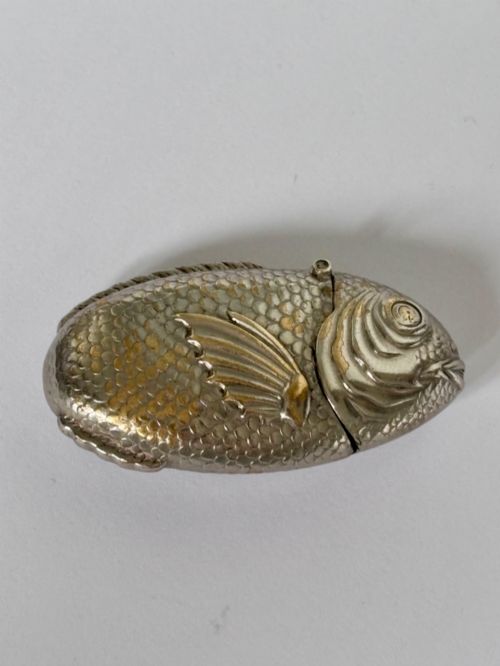 fig 1. A silver-plated brass vesta case cast in the shape of a carp with detailed body scales and a hinged head.