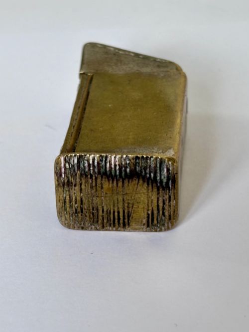 fig 2. An antique Victorian brass novelty vesta case designed as an outhouse with an opening door revealing a gentleman seated inside.