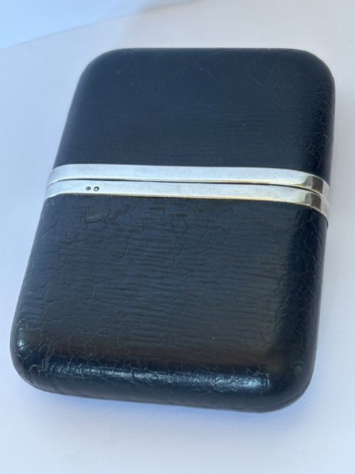 fig 1. An antique black textured leather cigar case featuring a central hallmarked 900 silver collar.