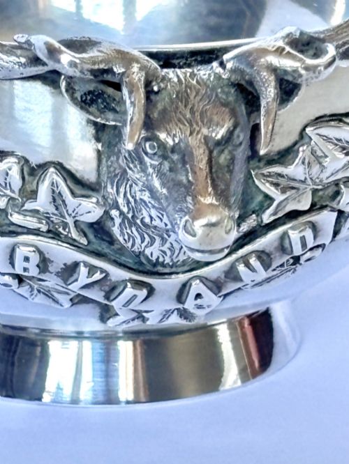 fig 2. Late Victorian Scottish silver quaich featuring cast stag head handles and an engraved military presentation inscription on a circular pedestal base.