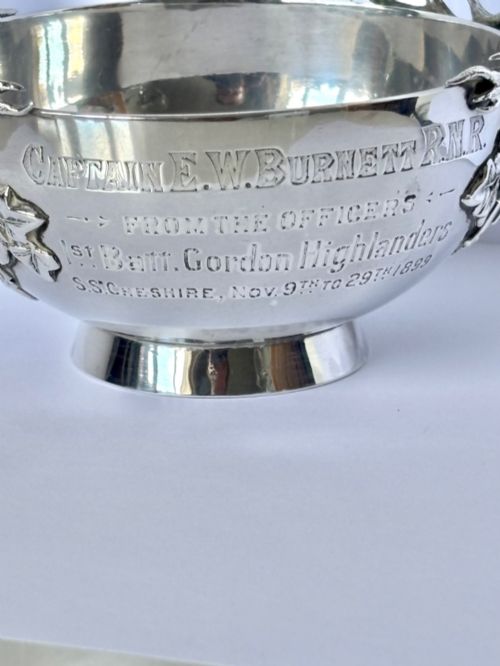 fig 3. Late Victorian Scottish silver quaich featuring cast stag head handles and an engraved military presentation inscription on a circular pedestal base.