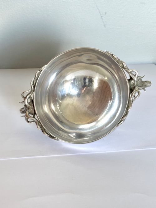 fig 5. Late Victorian Scottish silver quaich featuring cast stag head handles and an engraved military presentation inscription on a circular pedestal base.