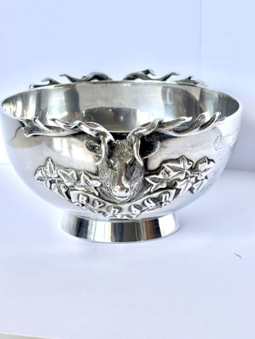 fig 7. Late Victorian Scottish silver quaich featuring cast stag head handles and an engraved military presentation inscription on a circular pedestal base.