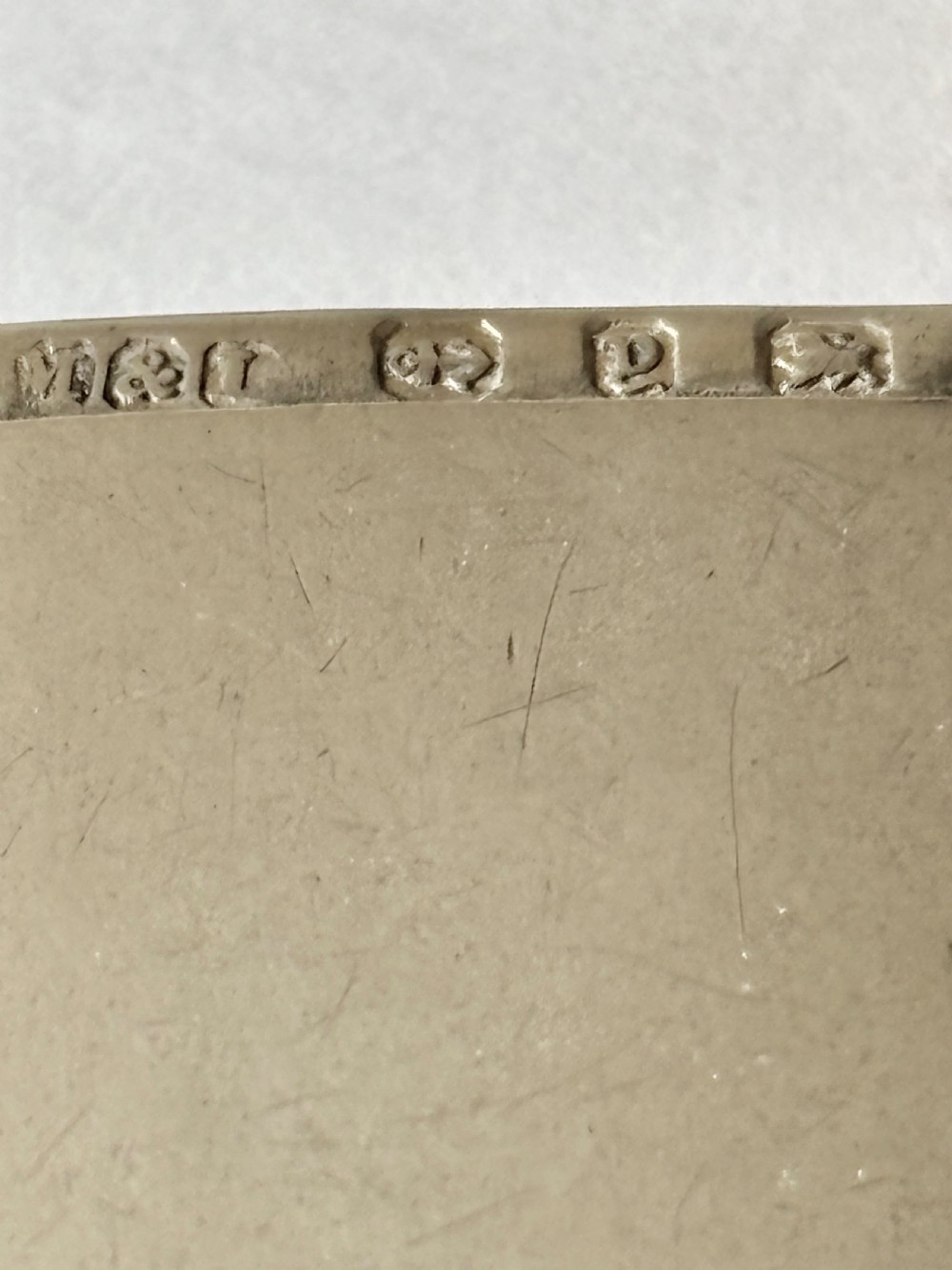 An opened Victorian sterling silver vesta case with an integrated oval photo frame, showing hinged covers and an interior gold wash. View IX