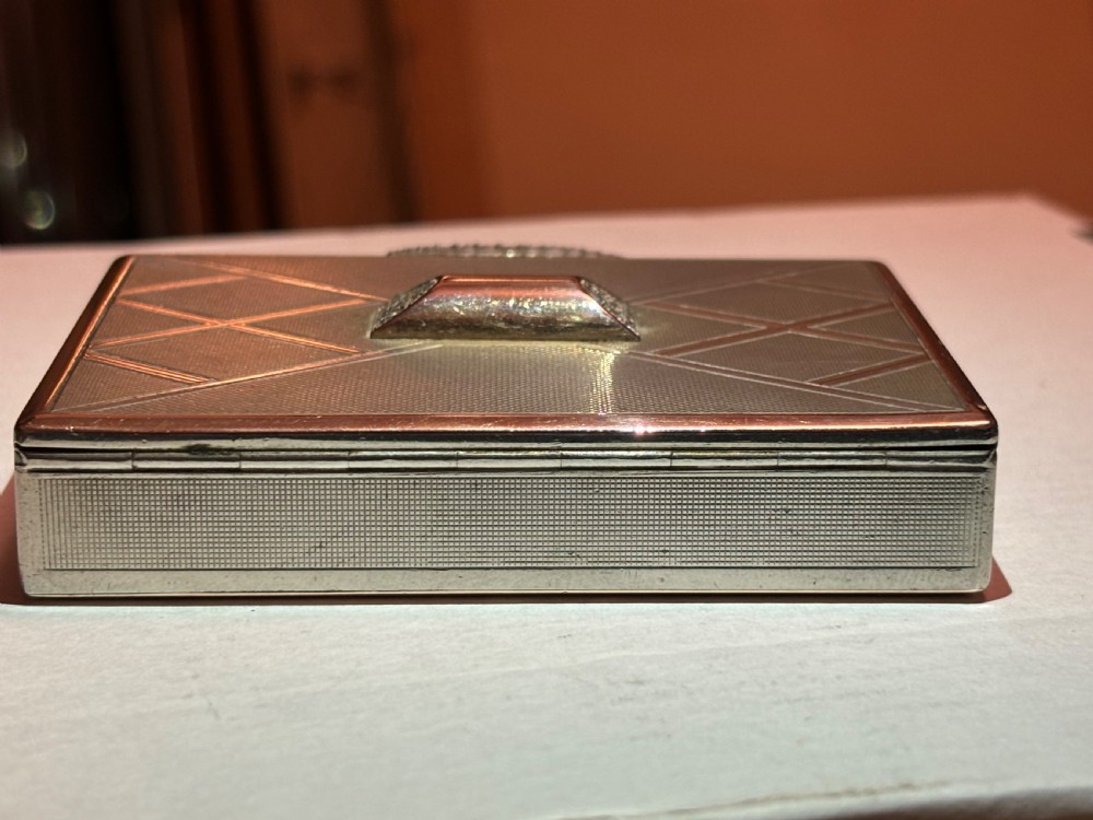 A square Art Deco rose gold vanity box featuring geometric engine-turned patterns and a diamond-paved catch. View III