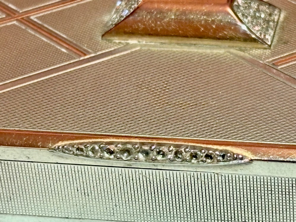 A square Art Deco rose gold vanity box featuring geometric engine-turned patterns and a diamond-paved catch. View IX