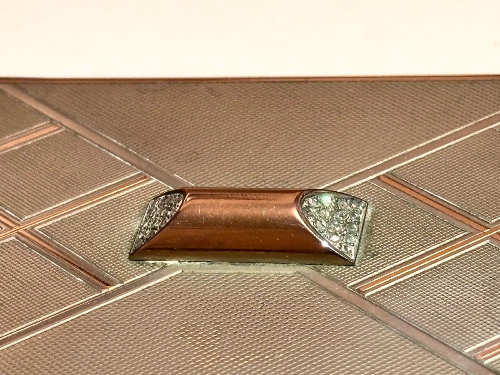 A square Art Deco rose gold vanity box featuring geometric engine-turned patterns and a diamond-paved catch. View X