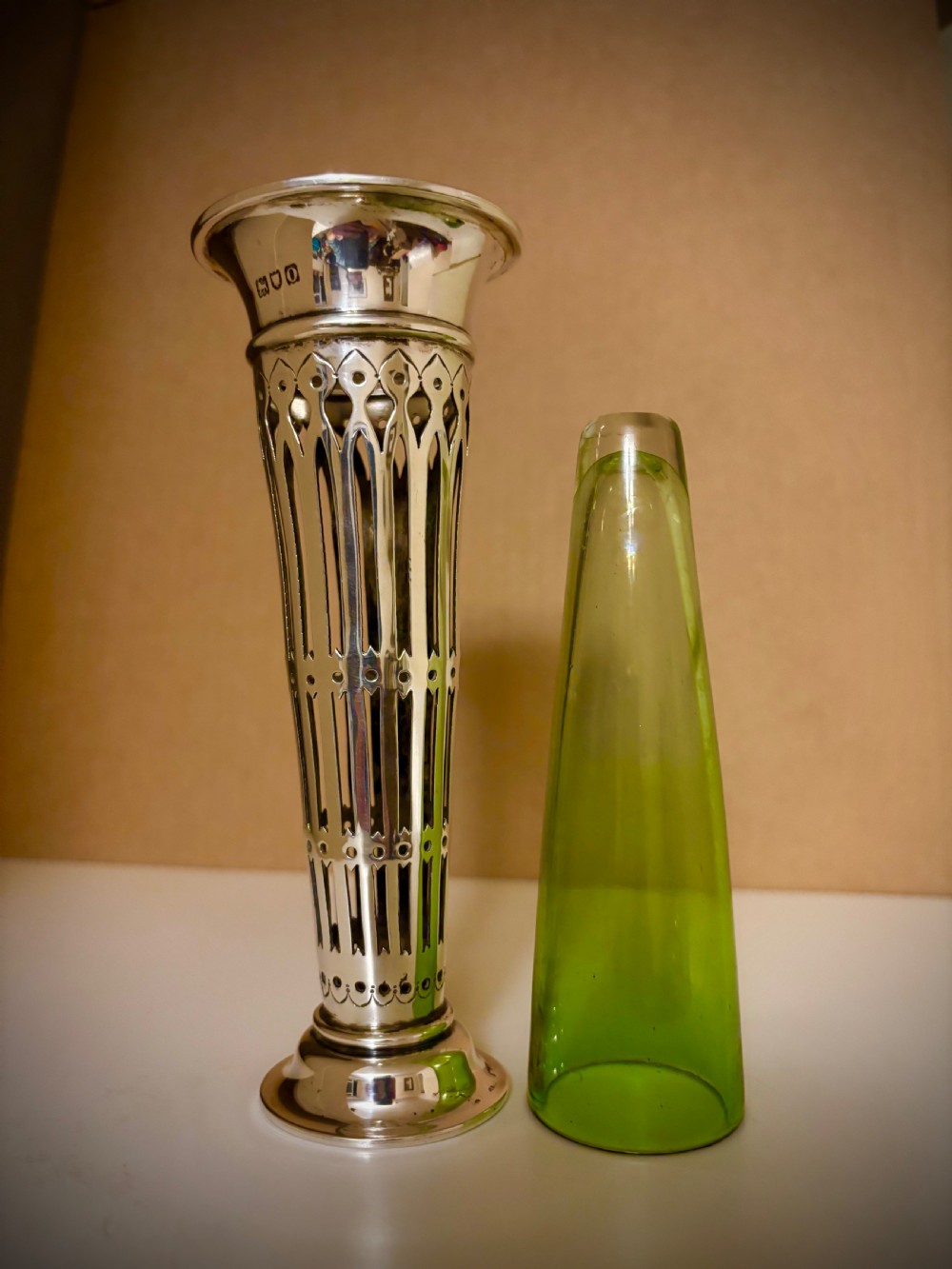 Top-down view of an Edwardian pierced sterling silver vase featuring a flared rim and a dark green glass liner. View II