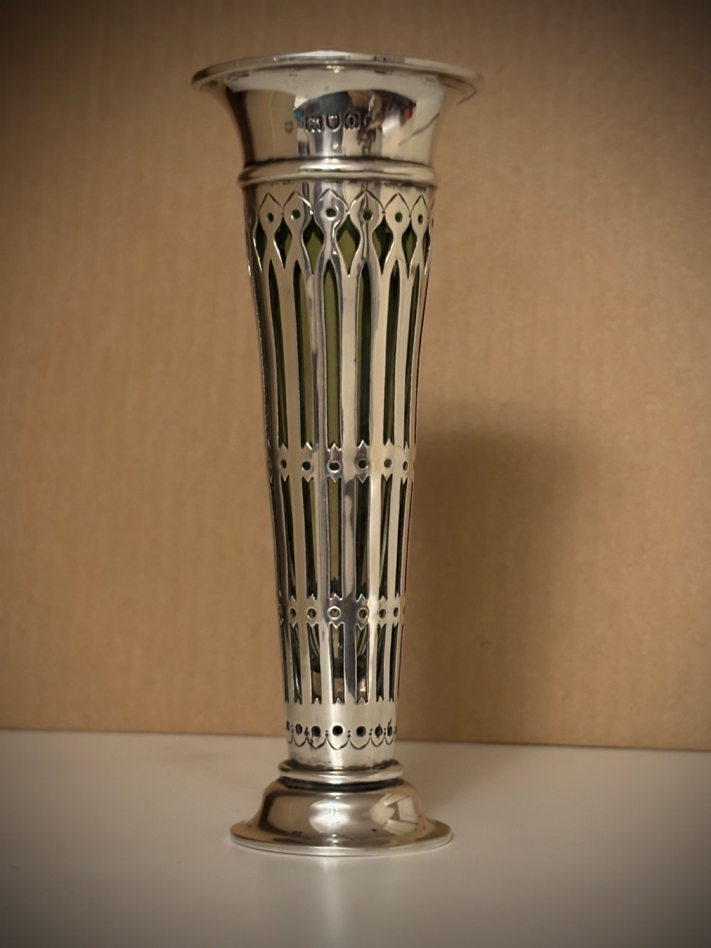 Top-down view of an Edwardian pierced sterling silver vase featuring a flared rim and a dark green glass liner. View V
