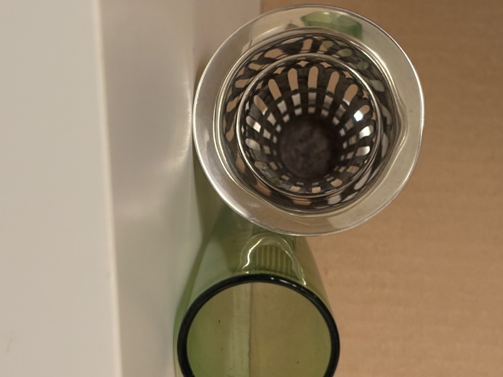 Top-down view of an Edwardian pierced sterling silver vase featuring a flared rim and a dark green glass liner. View VIII