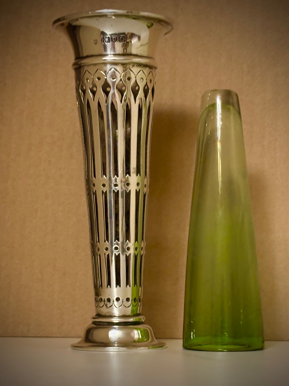 Top-down view of an Edwardian pierced sterling silver vase featuring a flared rim and a dark green glass liner. View IX