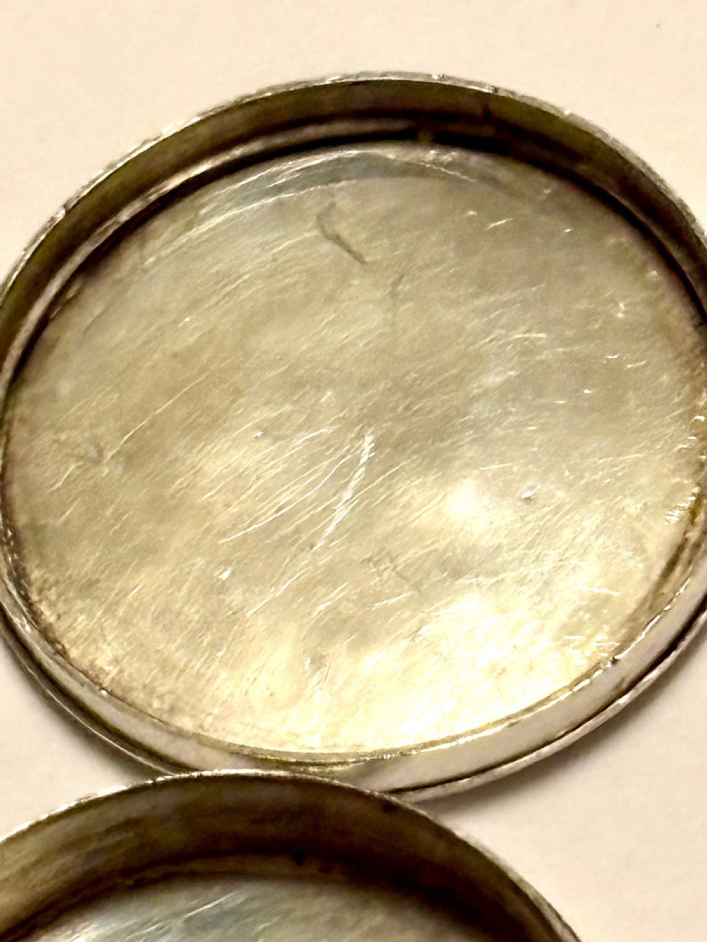 An oval George III sterling silver patch box featuring hand-engraved bright-cut decoration with a central shield motif. View VI