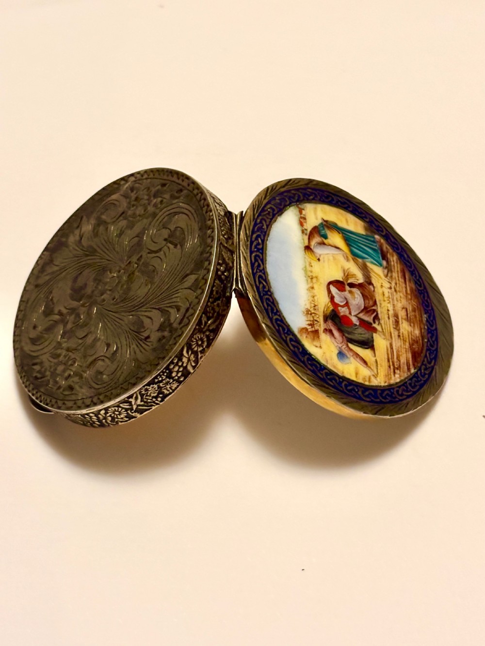 A circular vintage Italian 800 silver powder compact featuring a hand-painted enamel scene of harvest workers framed by a cobalt blue enamel border. View XV