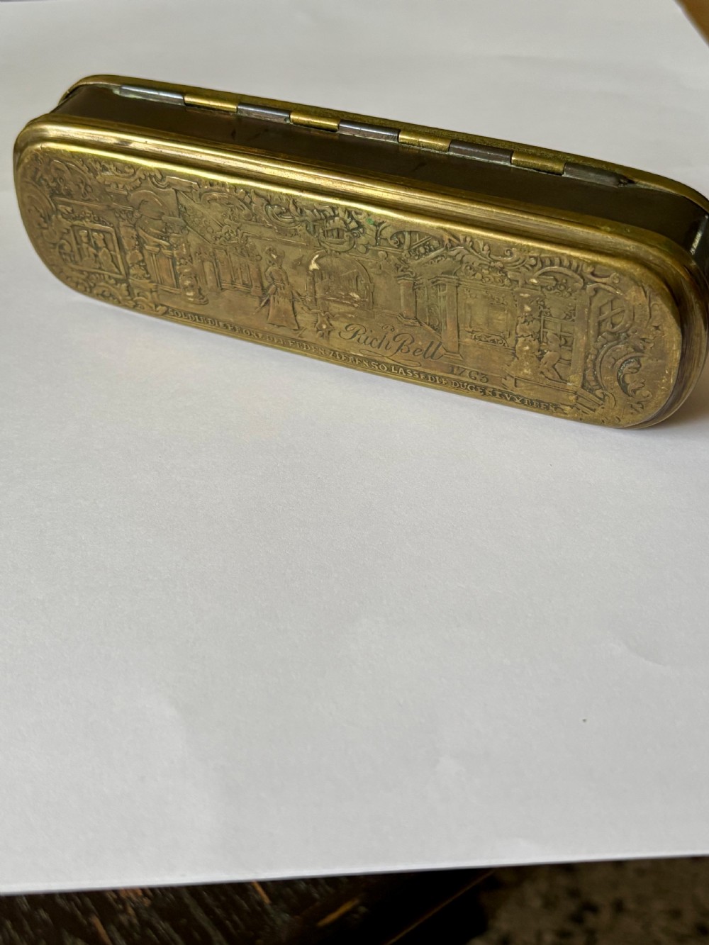 An oblong 18th-century brass and copper tobacco box featuring relief engravings of military battle scenes and portrait medallions on its lid. View XI