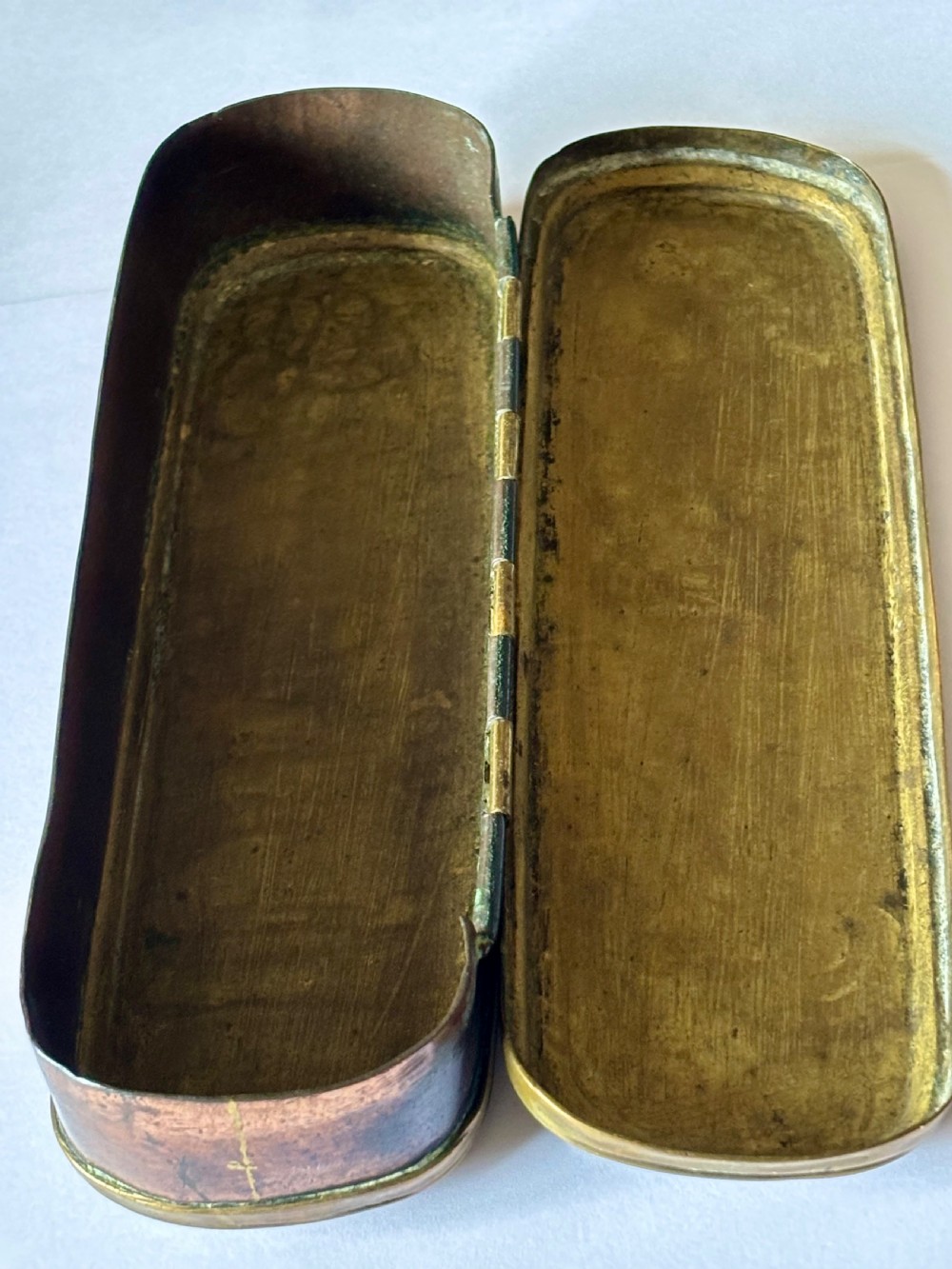 An oblong 18th-century brass and copper tobacco box featuring relief engravings of military battle scenes and portrait medallions on its lid. View XVI