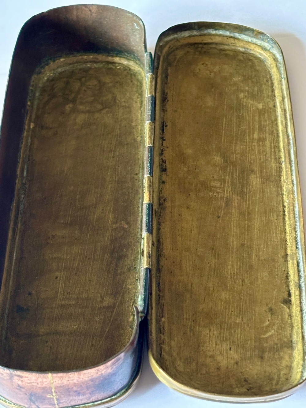 An oblong 18th-century brass and copper tobacco box featuring relief engravings of military battle scenes and portrait medallions on its lid. View XVII