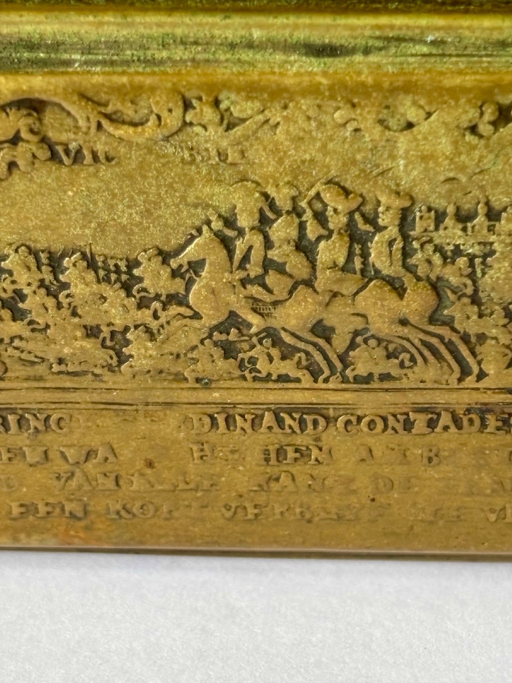 An oblong 18th-century brass and copper tobacco box featuring relief engravings of military battle scenes and portrait medallions on its lid. View XXI
