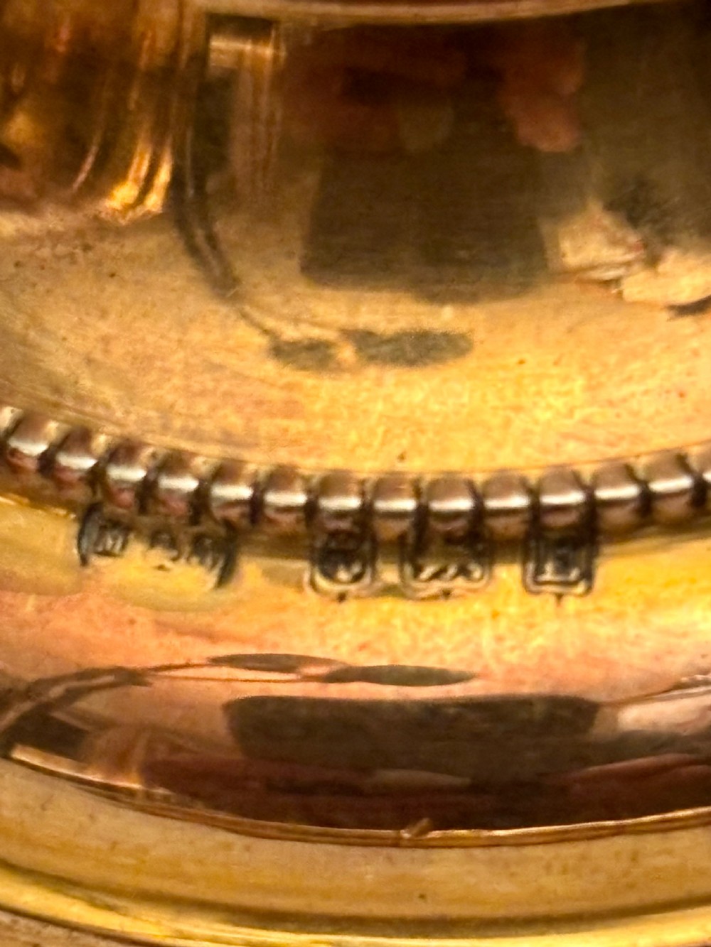 An open fitted presentation box containing two silver gilt candlesticks, a central inkwell, and a dip pen. View VIII