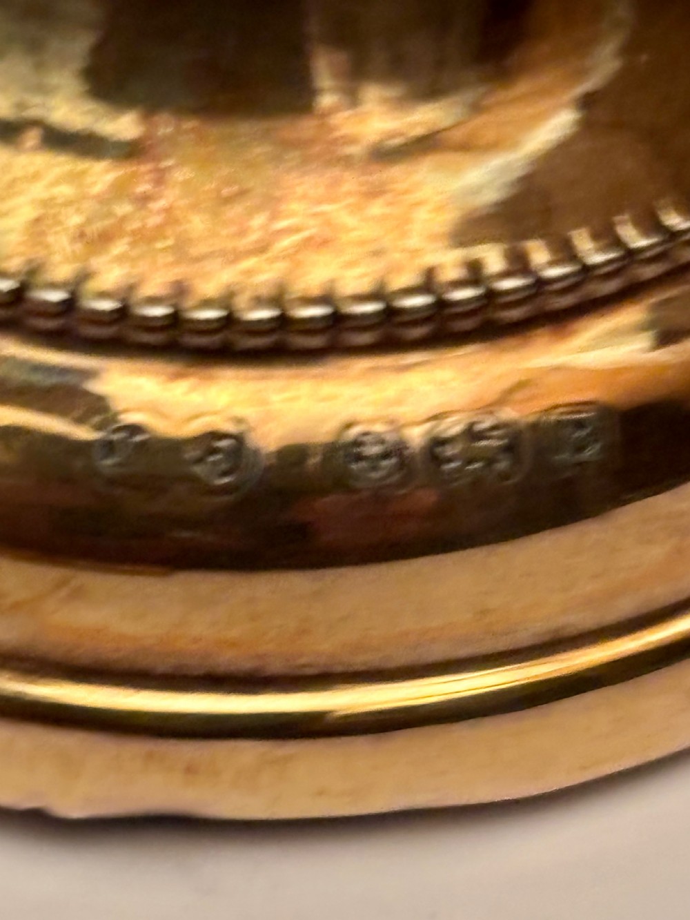 An open fitted presentation box containing two silver gilt candlesticks, a central inkwell, and a dip pen. View IX
