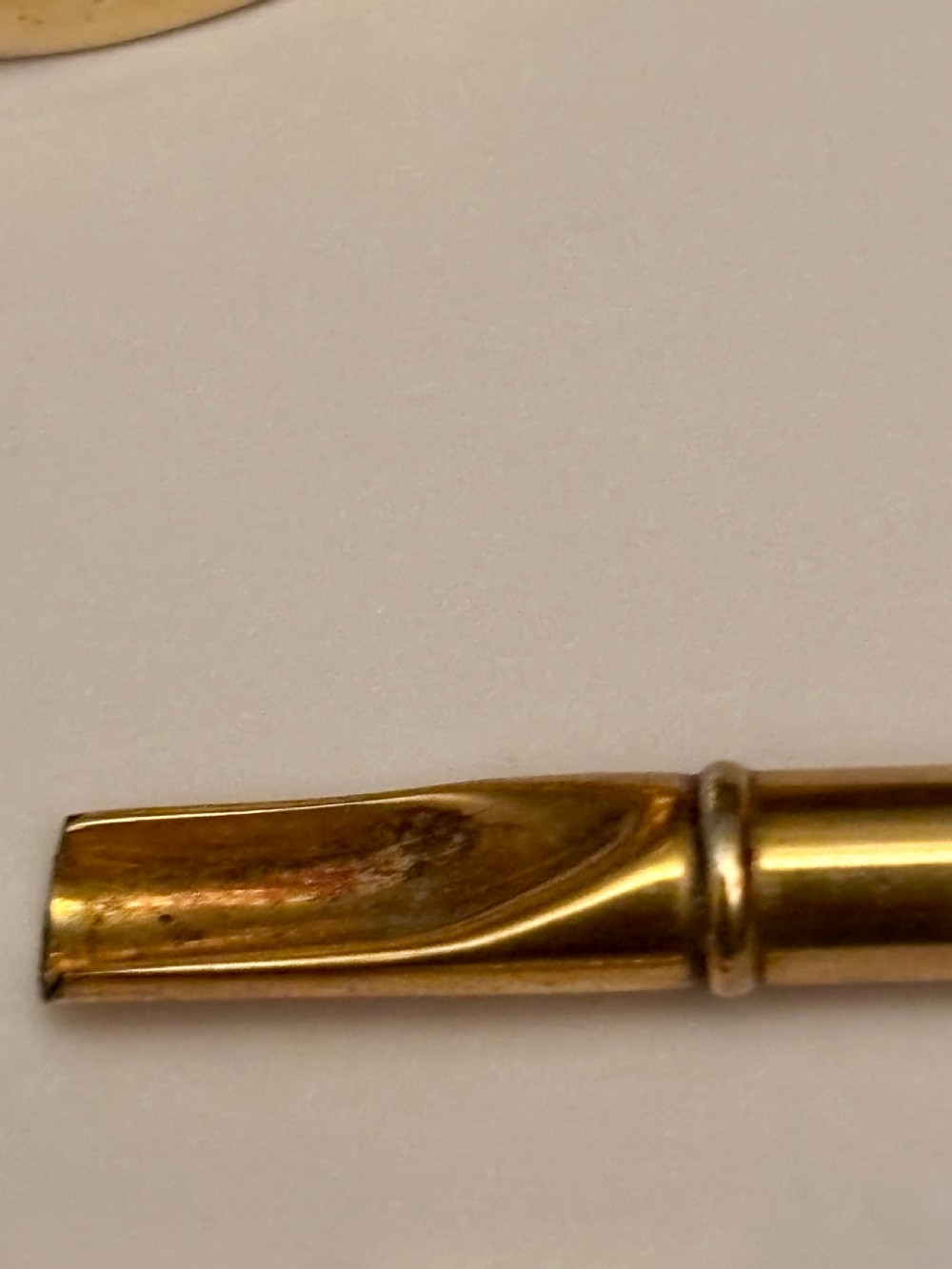 An open fitted presentation box containing two silver gilt candlesticks, a central inkwell, and a dip pen. View XII
