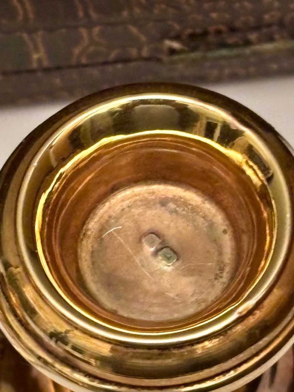 An open fitted presentation box containing two silver gilt candlesticks, a central inkwell, and a dip pen. View XIV