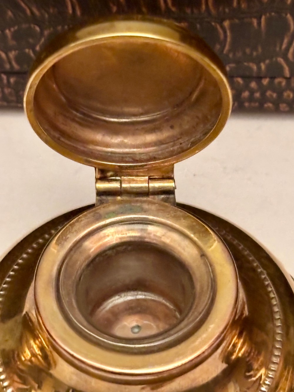 An open fitted presentation box containing two silver gilt candlesticks, a central inkwell, and a dip pen. View XVI