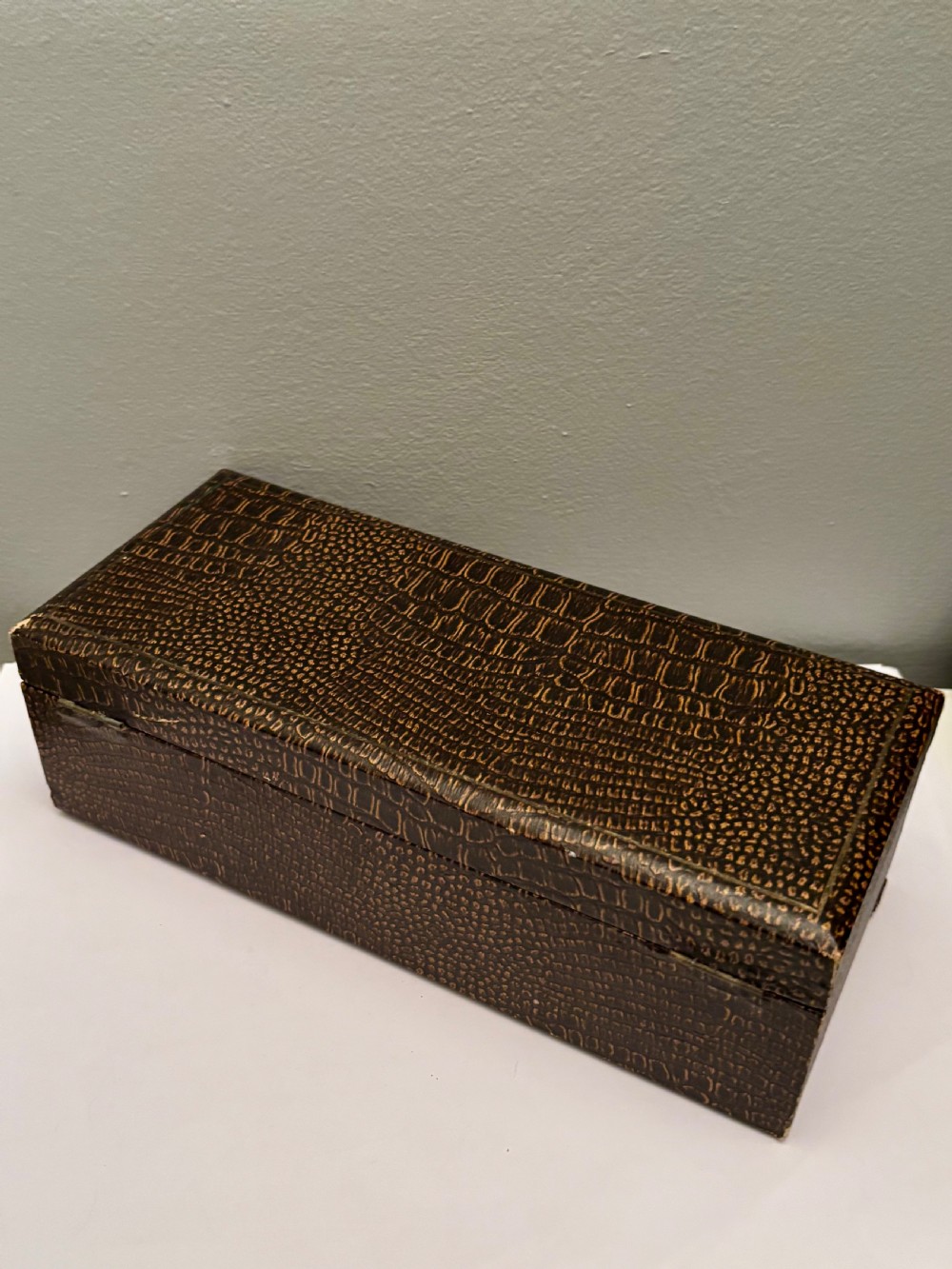 An open fitted presentation box containing two silver gilt candlesticks, a central inkwell, and a dip pen. View XVII