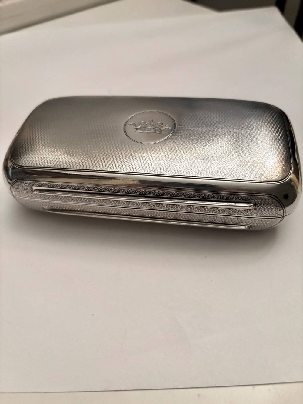 A rectangular Victorian sterling silver box featuring fine engine-turned geometric engraving and a central engraved coronet crest. View III