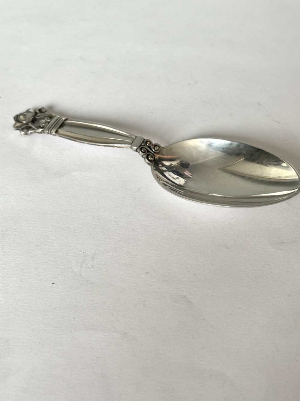 A sterling silver tea caddy spoon featuring a rounded bowl and an acorn motif finial. View VIII