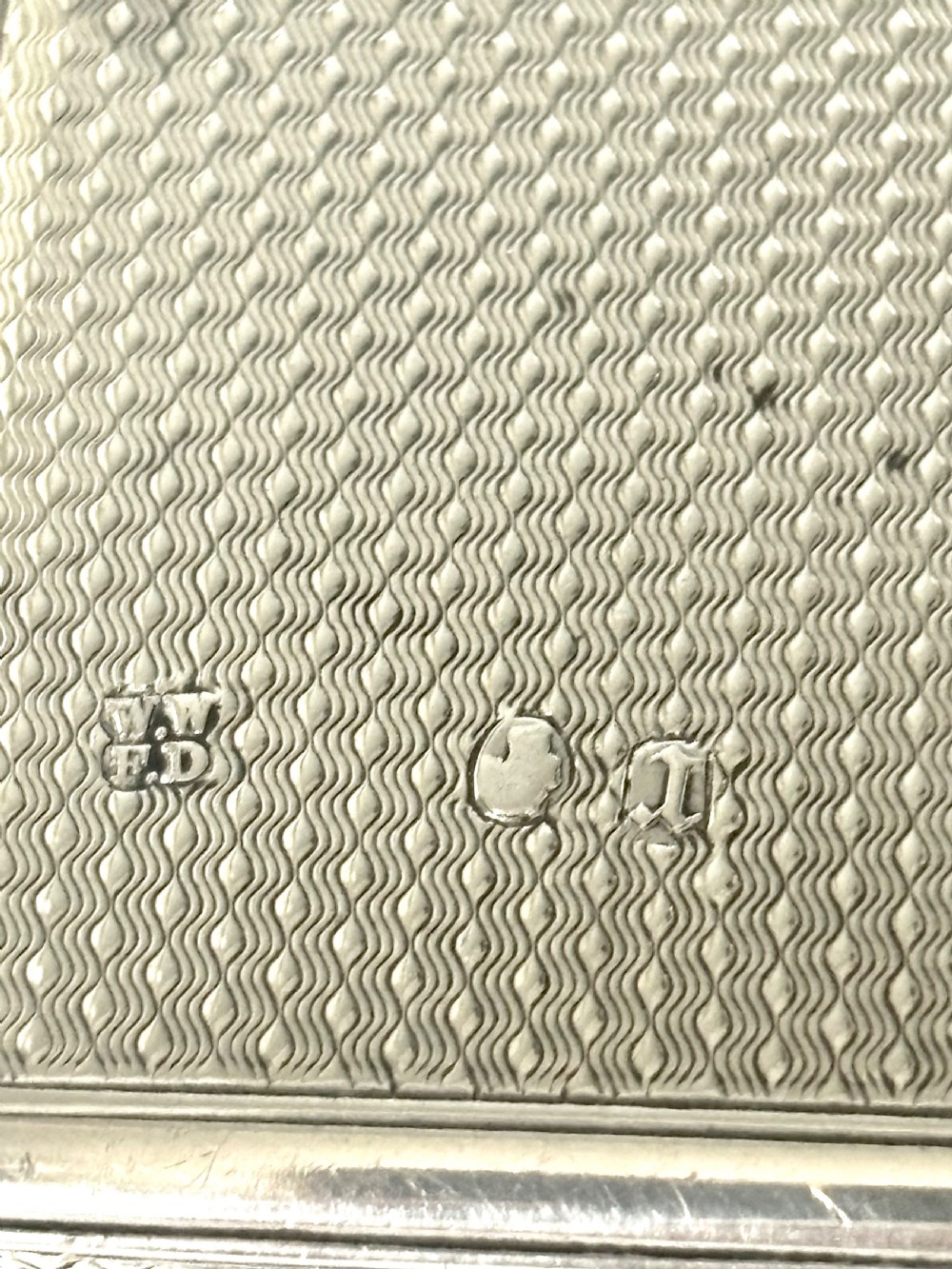 A Victorian sterling silver purse with engine-turned geometric engraving, shown open with a blue silk concertina lining beside a detachable silver case. View VII