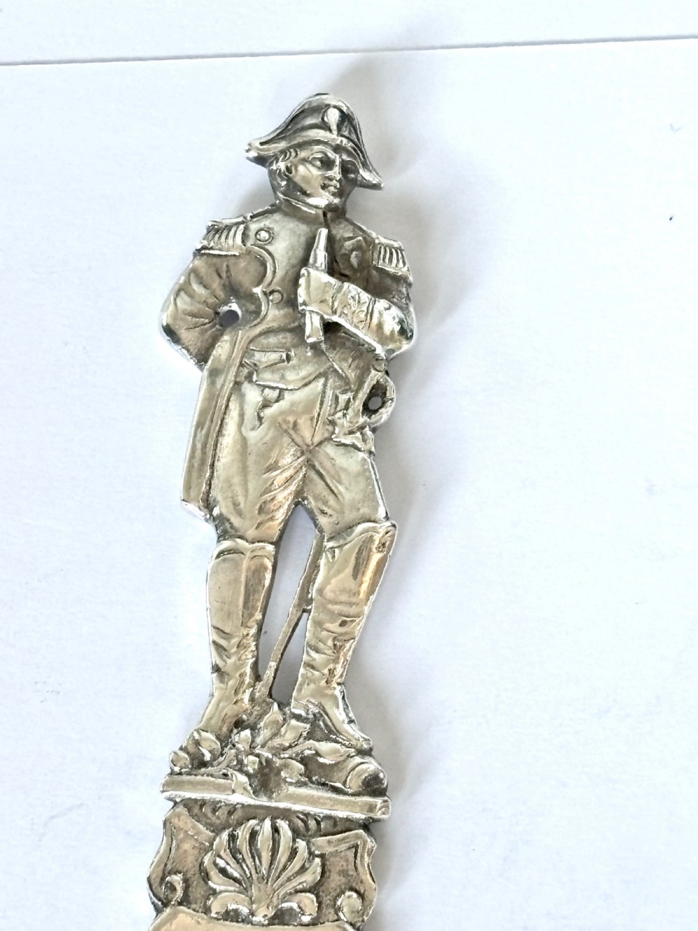 An Edwardian sterling silver letter opener featuring a cast figure of Napoleon on the handle and an engraved laurel wreath on the blade. View IV