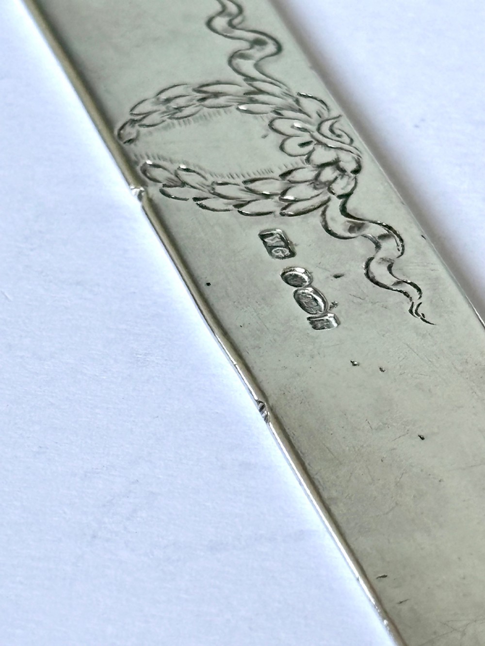 An Edwardian sterling silver letter opener featuring a cast figure of Napoleon on the handle and an engraved laurel wreath on the blade. View VII