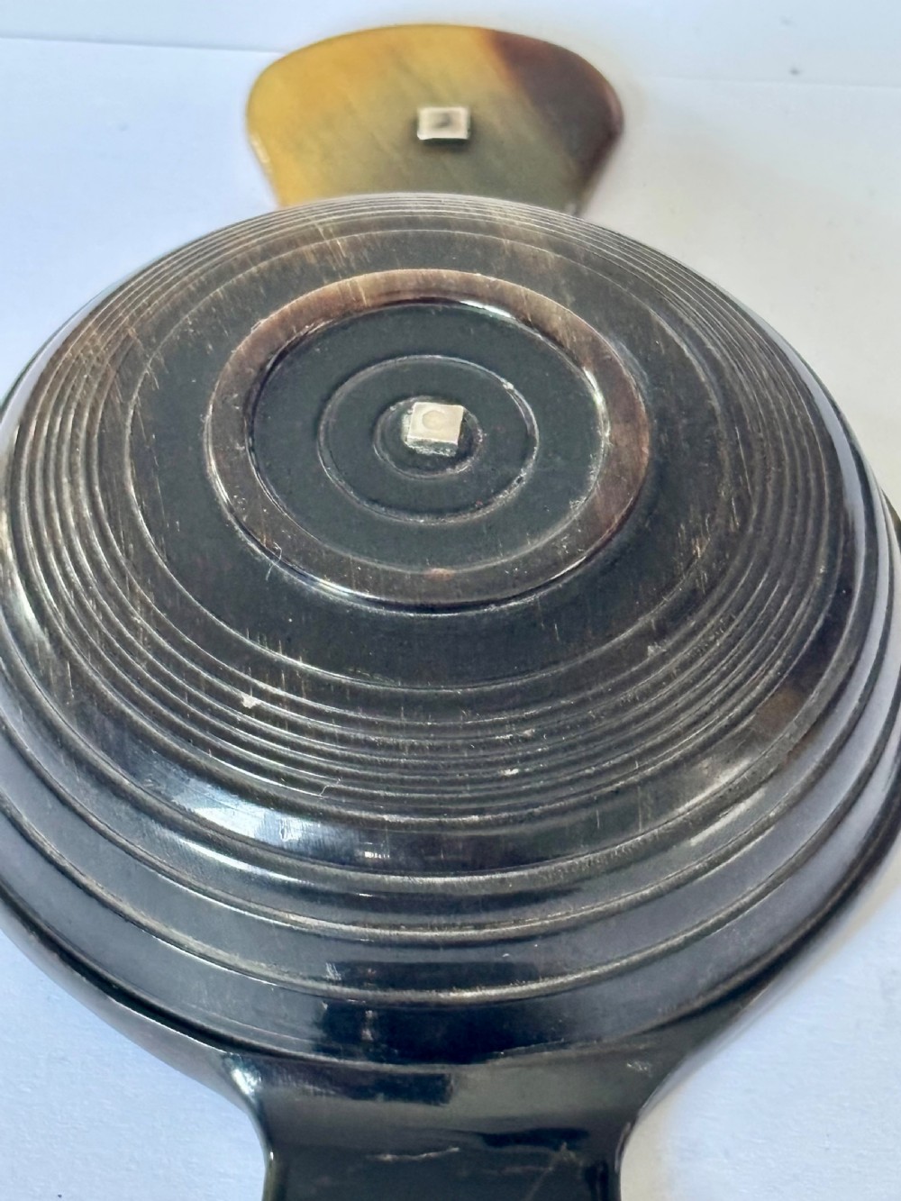 An antique Scottish horn quaich featuring carved lug handles with hallmarked silver thistle and Celtic cross mounts, and an inscribed silver central boss inside the bowl. View VII