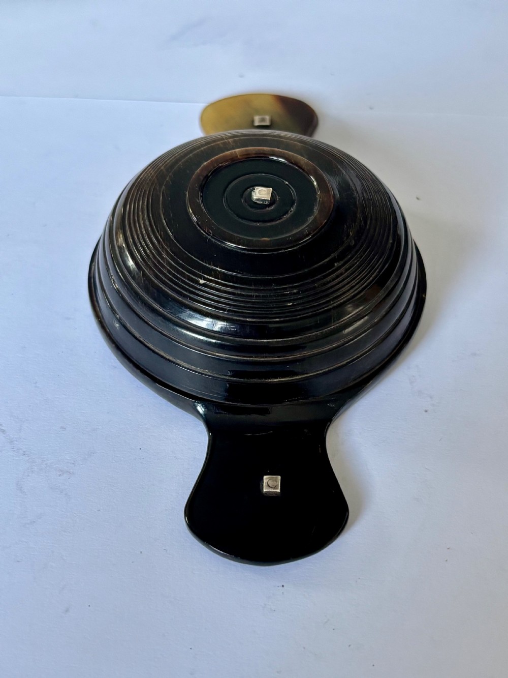 An antique Scottish horn quaich featuring carved lug handles with hallmarked silver thistle and Celtic cross mounts, and an inscribed silver central boss inside the bowl. View VIII