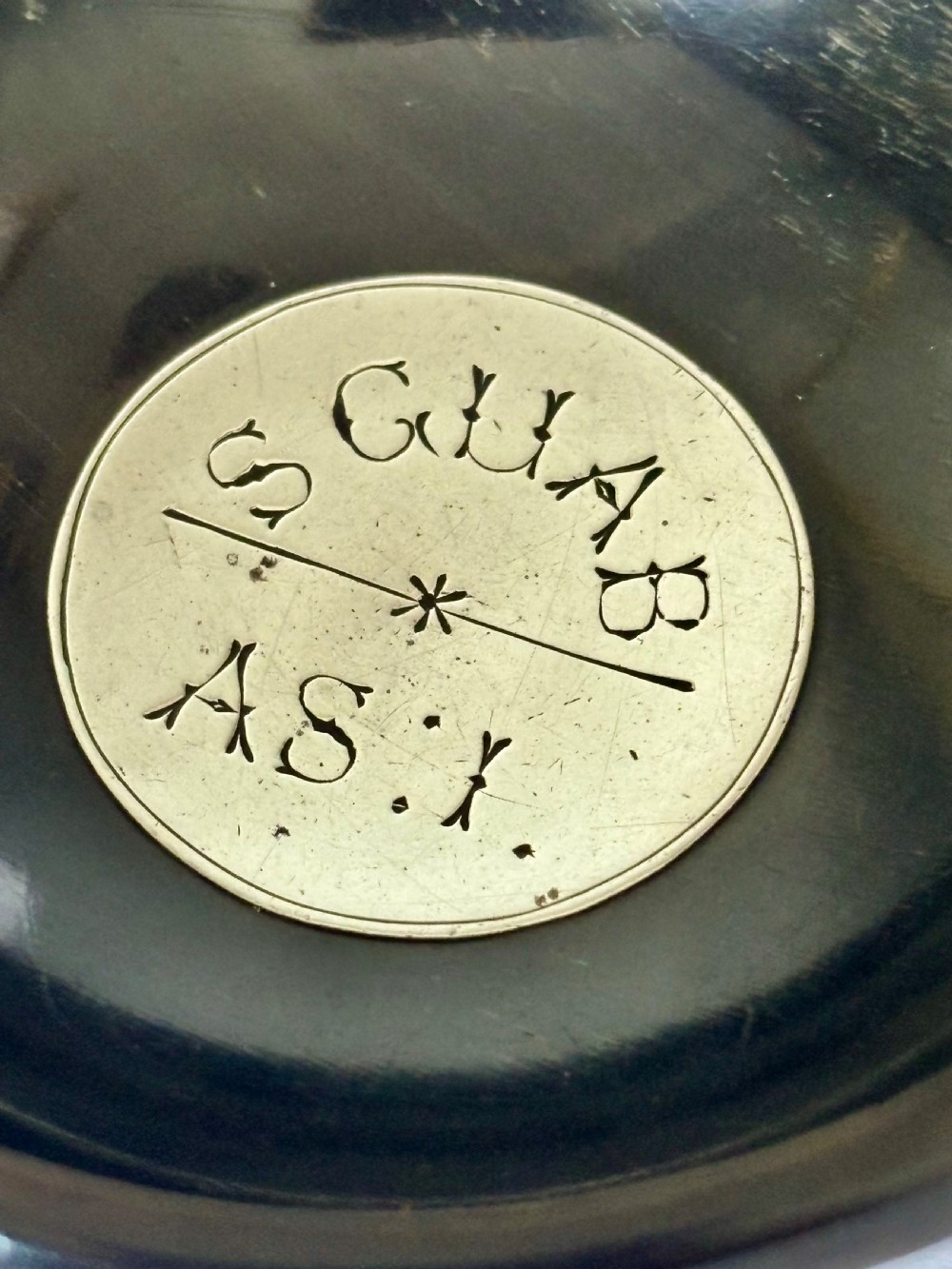 An antique Scottish horn quaich featuring carved lug handles with hallmarked silver thistle and Celtic cross mounts, and an inscribed silver central boss inside the bowl. View IX