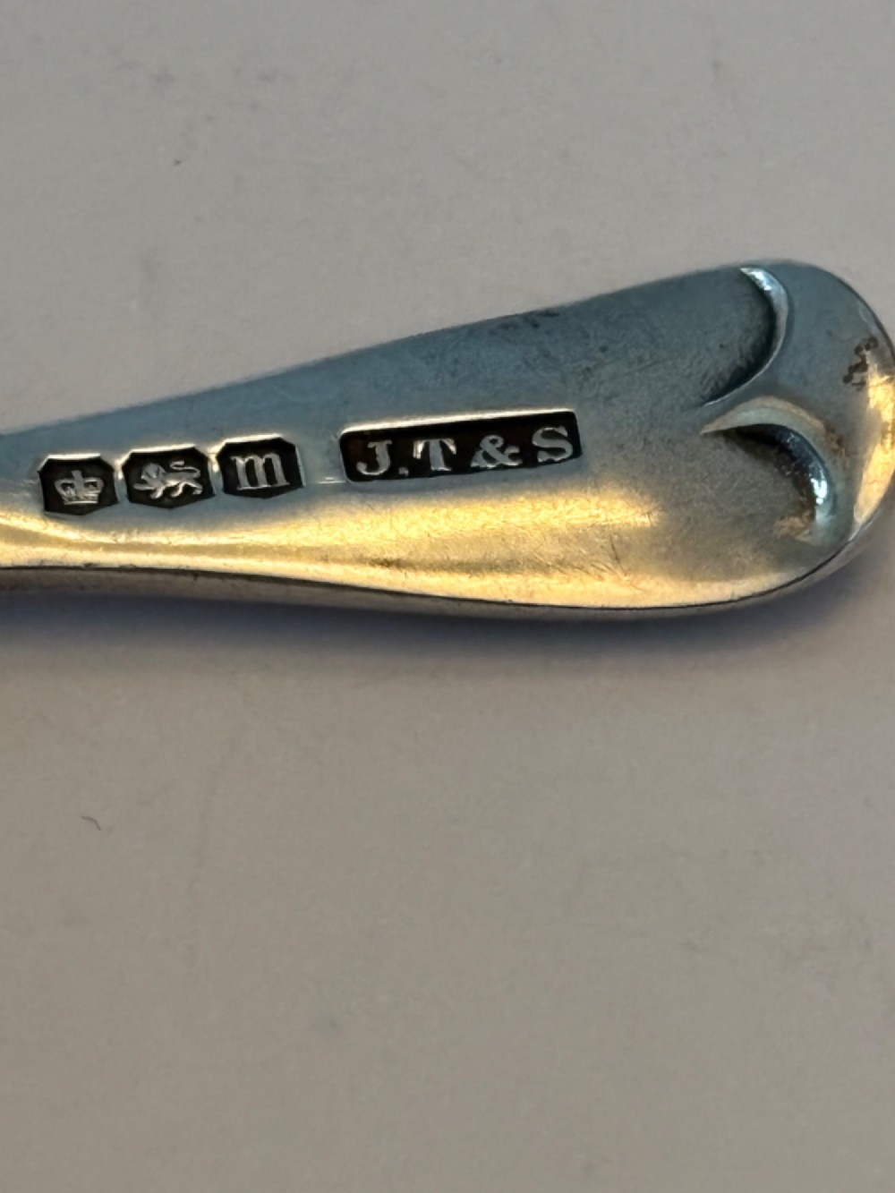 A George V sterling silver tea caddy spoon with a wide oval bowl and an engraved monogrammed handle. View III
