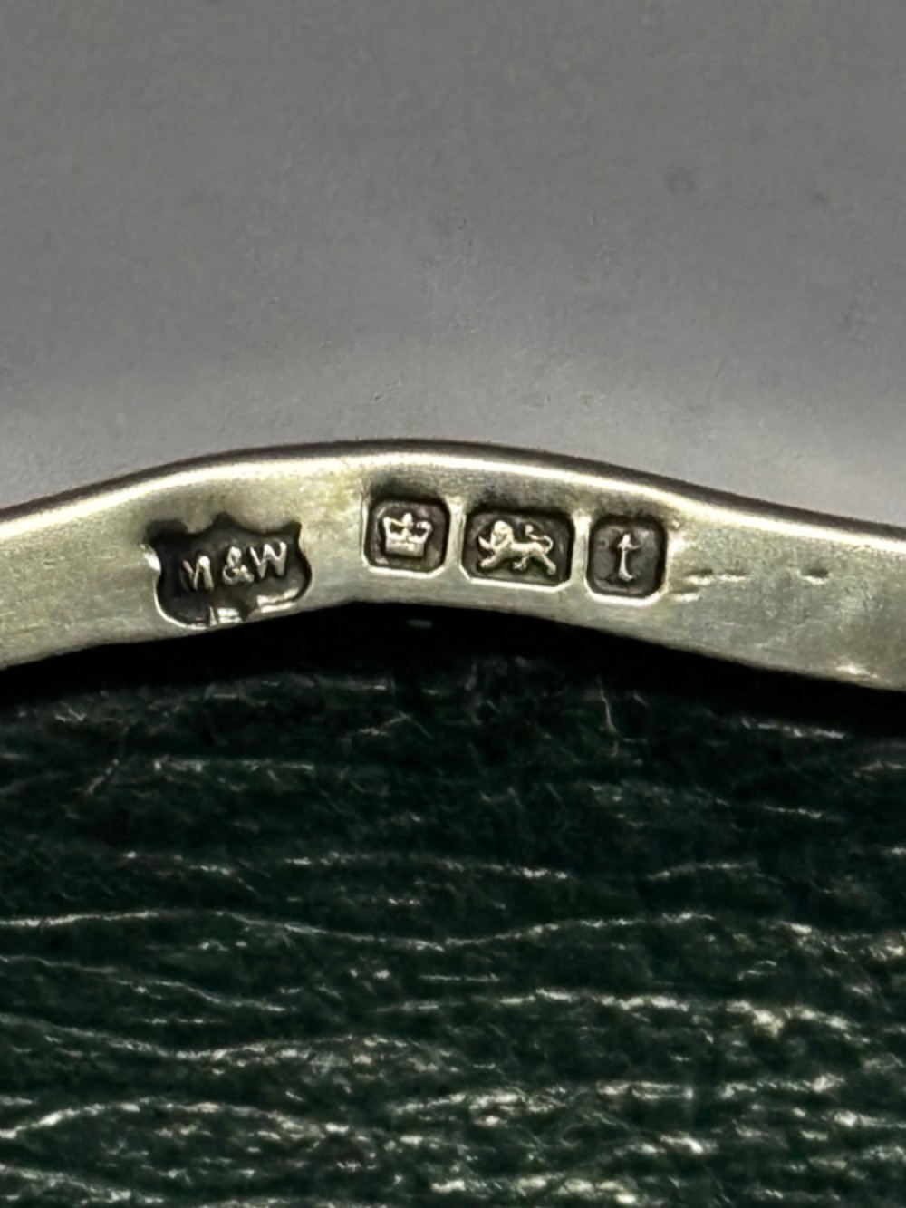An open George V sterling silver trinket box featuring green velvet lining, gilt lid interior, and cabriole feet. View III