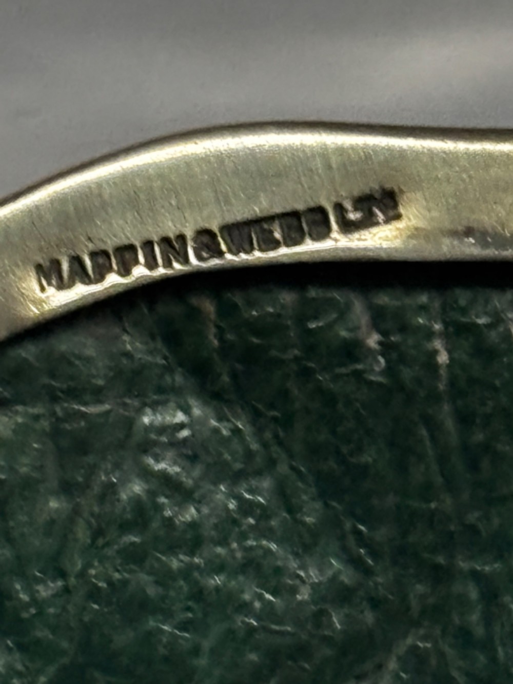 An open George V sterling silver trinket box featuring green velvet lining, gilt lid interior, and cabriole feet. View IV
