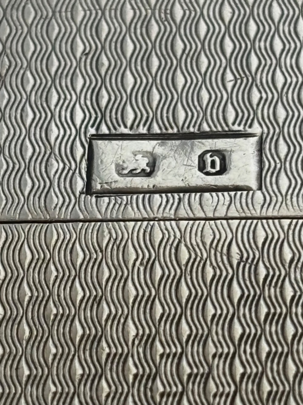 An antique Victorian sterling silver calling card case featuring shaped wavy edges, an engine-turned pattern, and an oval central cartouche. View VIII